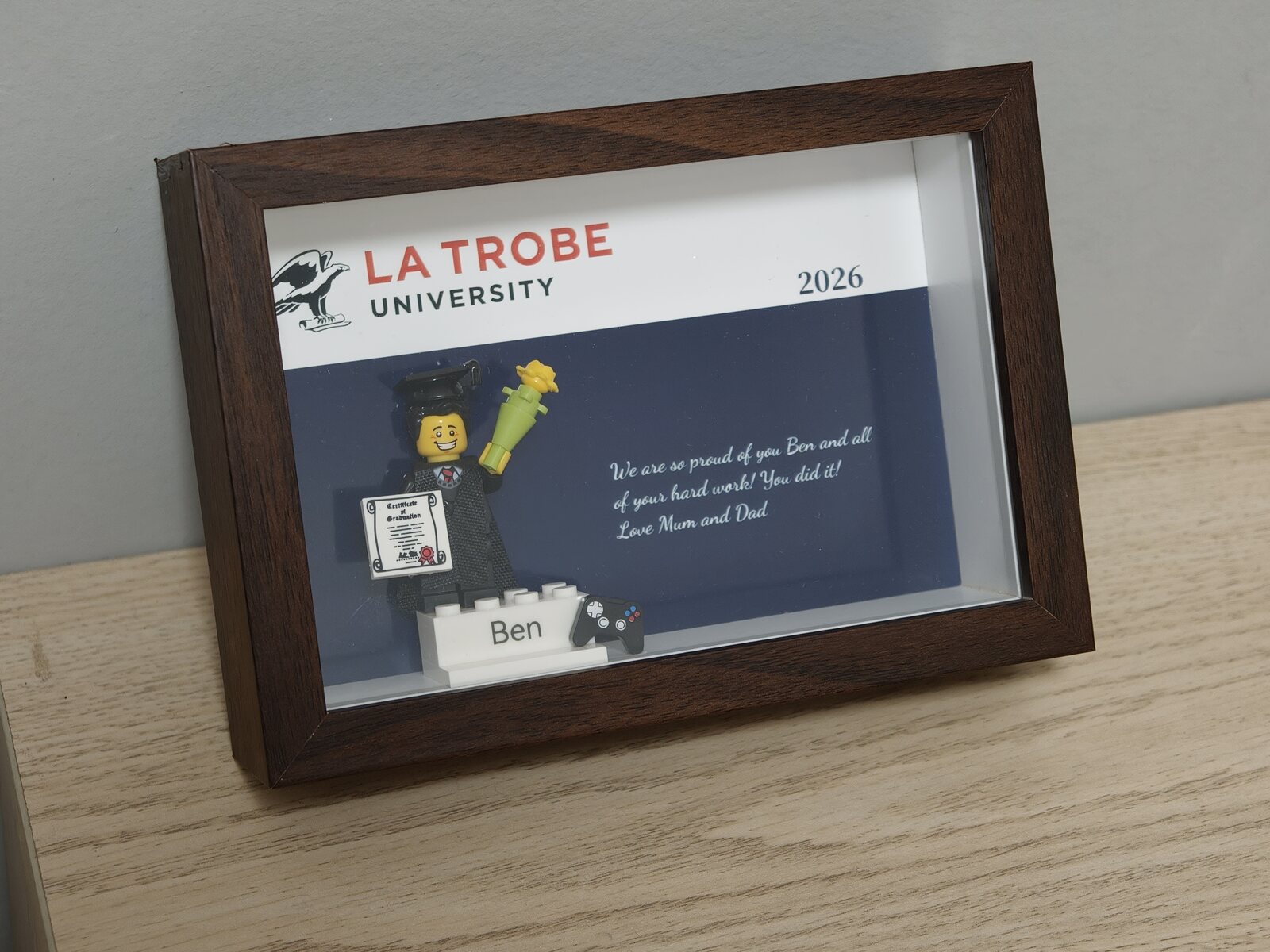 Completed personalised graduation order in a walnut frame