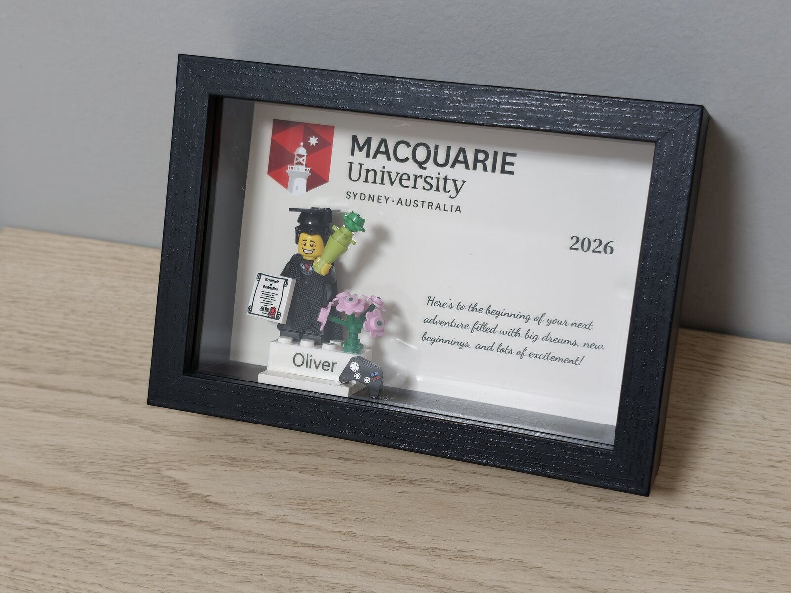 Completed personalised graduation order in a black frame