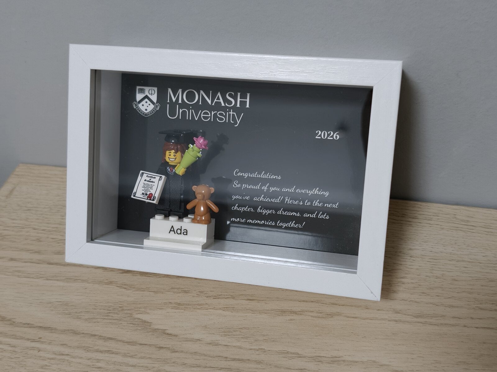 Completed personalised graduation order in a white frame