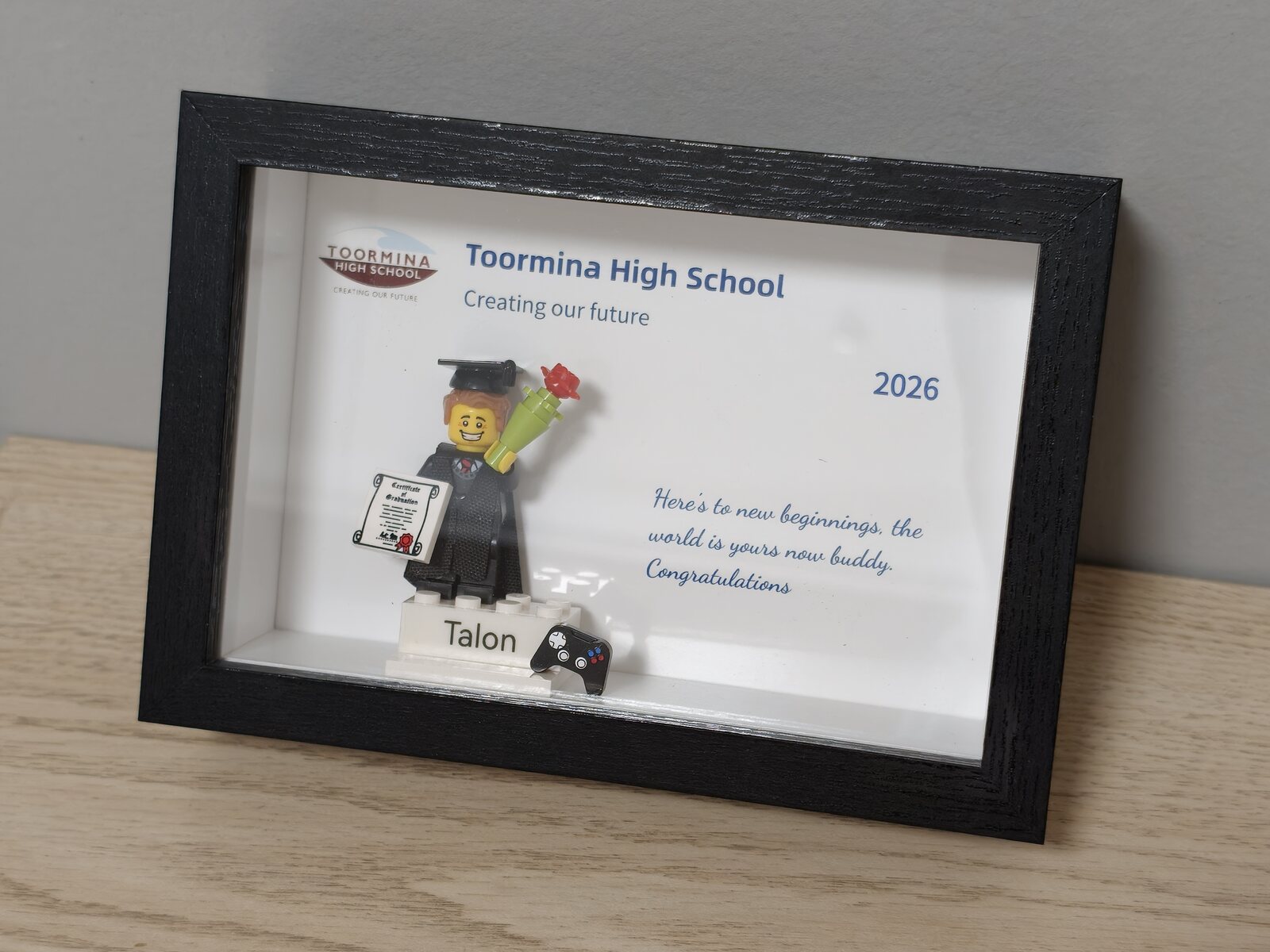 Completed personalised graduation order in a black frame